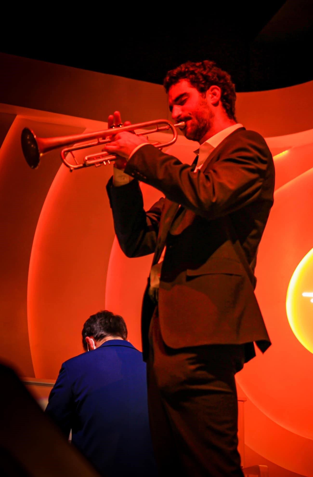 Andrew Wagner performing under red stage lights