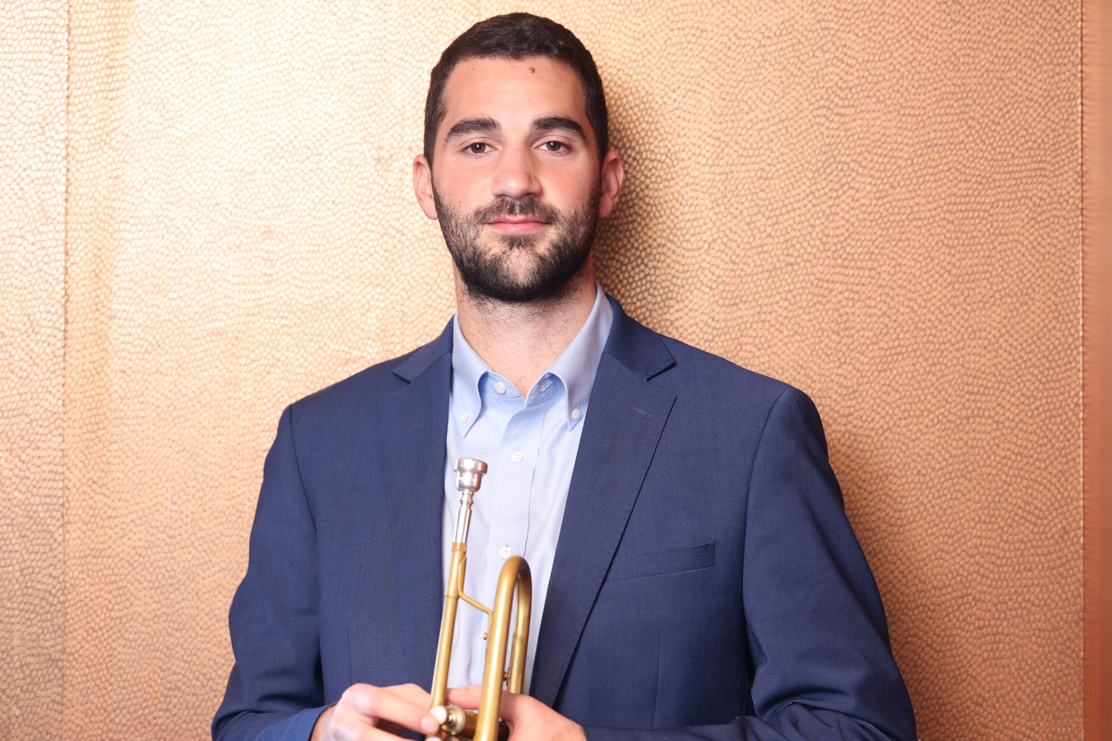 Portrait of Andrew Wagner holding his trumpet